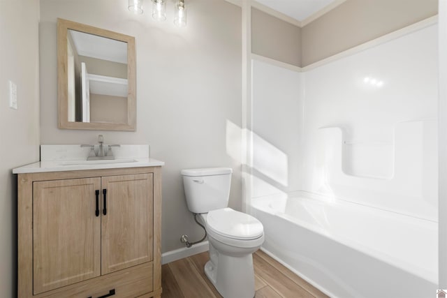 full bathroom with hardwood / wood-style floors, vanity, toilet, and shower / bath combination