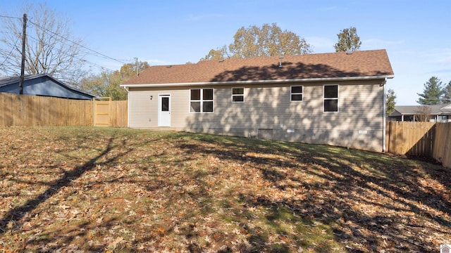 back of house with a lawn