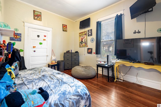 bedroom featuring dark wood-type flooring and ornamental molding