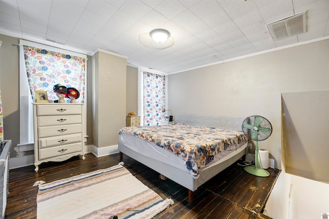 bedroom featuring dark hardwood / wood-style floors and crown molding