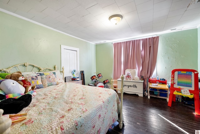 bedroom with crown molding and dark hardwood / wood-style flooring