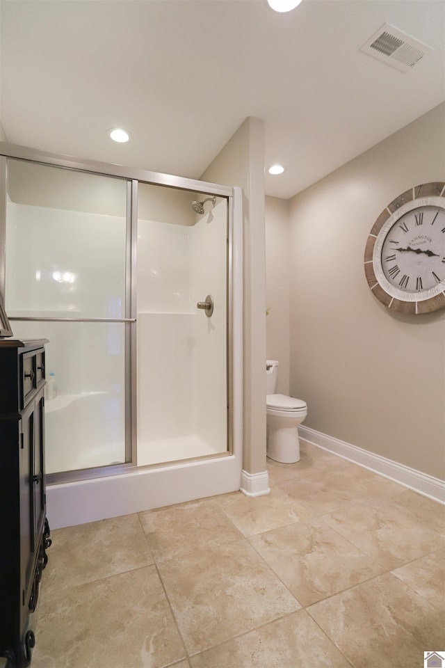 bathroom featuring tile patterned floors, toilet, and walk in shower