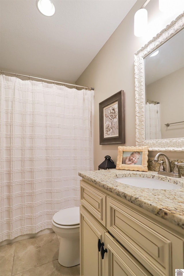 bathroom with tile patterned floors, vanity, and toilet