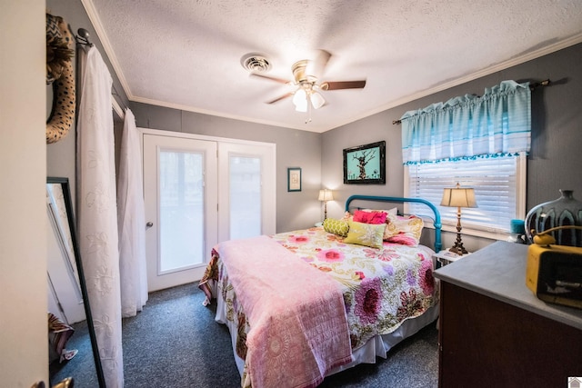 bedroom with a textured ceiling, dark carpet, ceiling fan, and ornamental molding