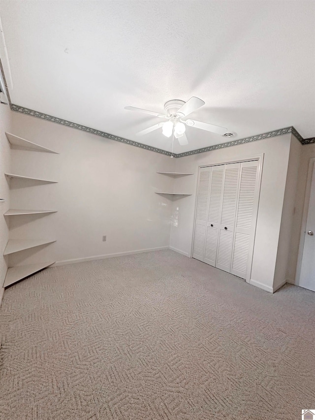 unfurnished bedroom featuring ceiling fan, carpet floors, and a closet