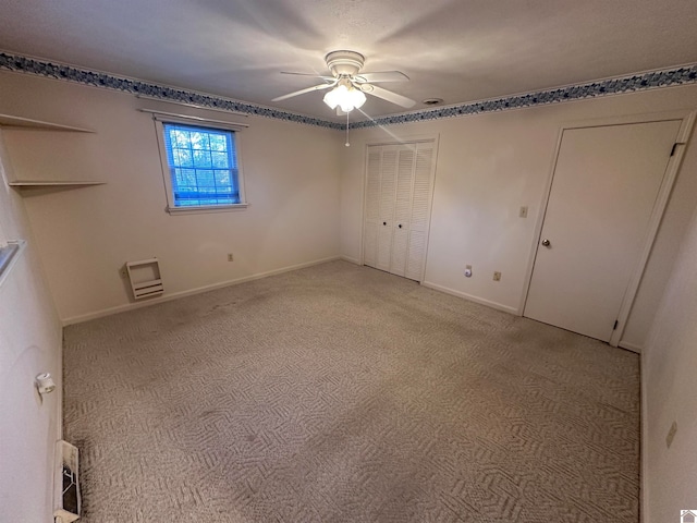 unfurnished bedroom featuring light colored carpet and ceiling fan