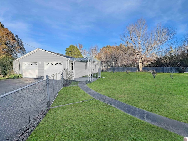 view of side of property featuring a lawn and a garage