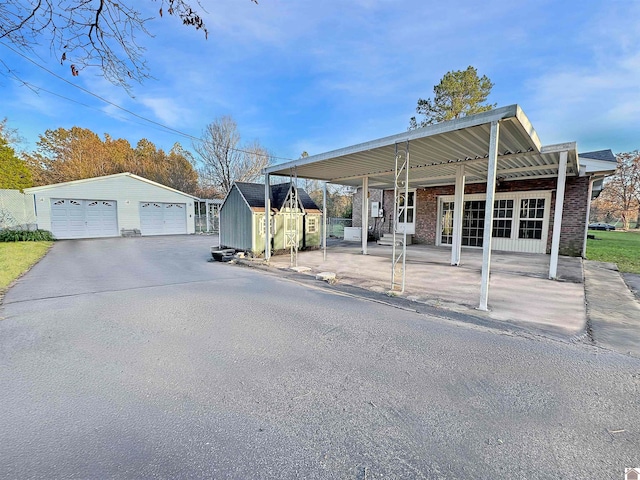 view of front of house with an outbuilding and a garage