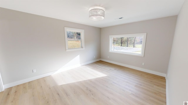 spare room featuring light hardwood / wood-style floors