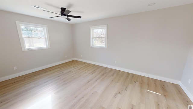 unfurnished room featuring light hardwood / wood-style flooring, a wealth of natural light, and ceiling fan