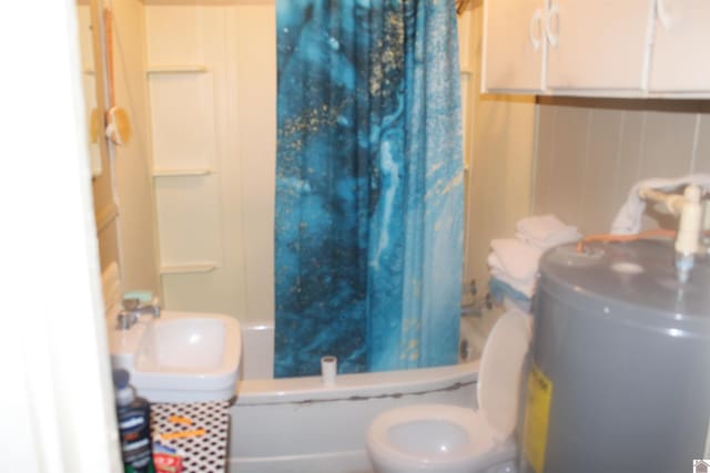 full bathroom featuring electric water heater, sink, shower / bathtub combination with curtain, and toilet