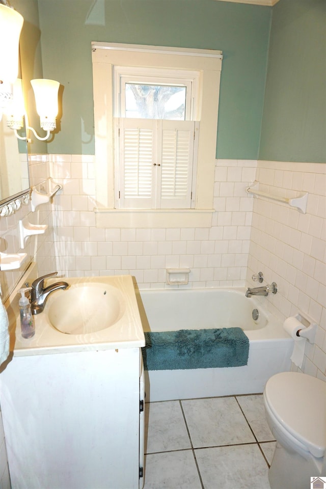 bathroom featuring a bathtub, vanity, tile walls, tile patterned flooring, and toilet