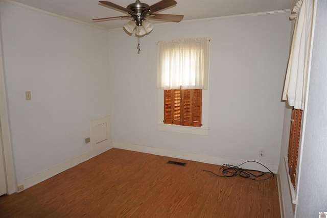 unfurnished room featuring hardwood / wood-style flooring, ceiling fan, and crown molding