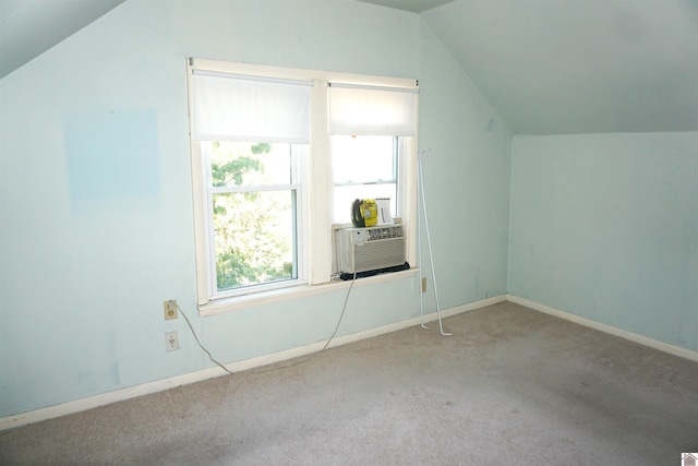 additional living space featuring light carpet, vaulted ceiling, and cooling unit