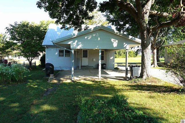 rear view of property with a lawn