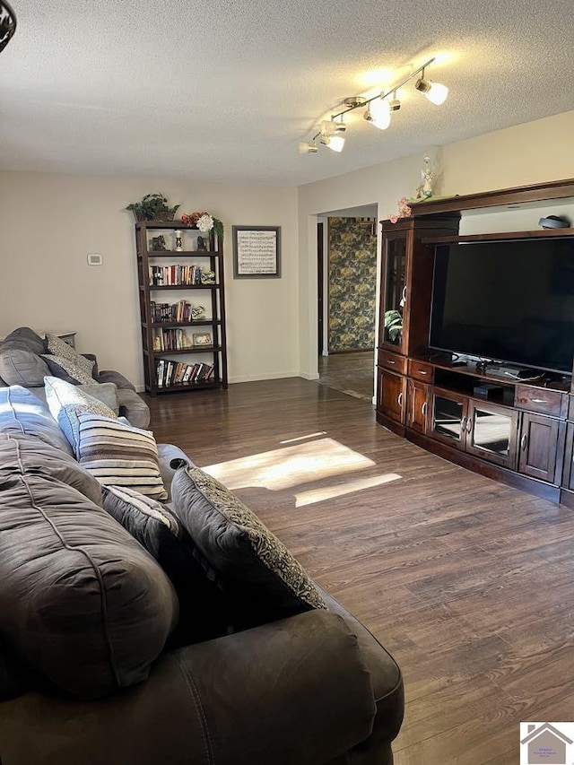 living room with dark wood-type flooring and a textured ceiling