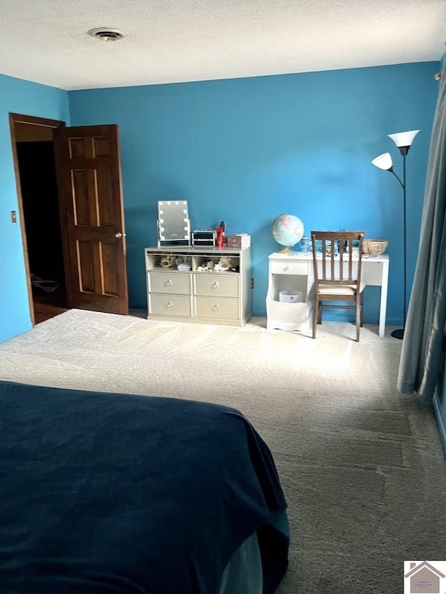 carpeted bedroom with a textured ceiling