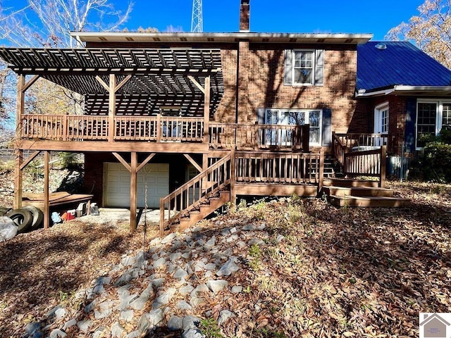 rear view of house with a garage and a deck