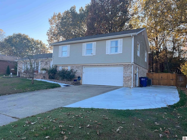 view of front of property featuring a garage and a front lawn