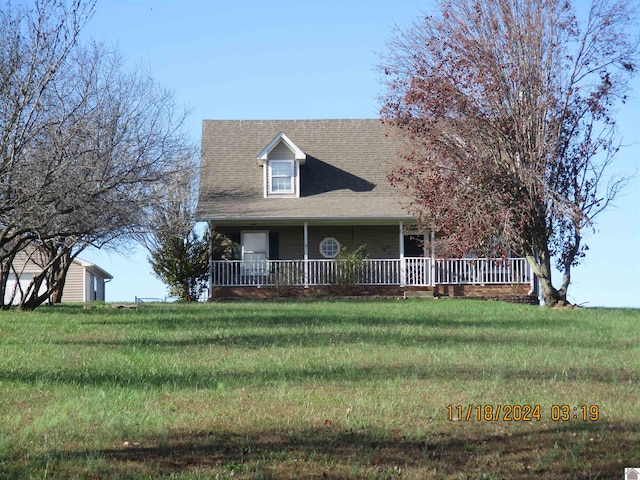 cape cod house with a front lawn