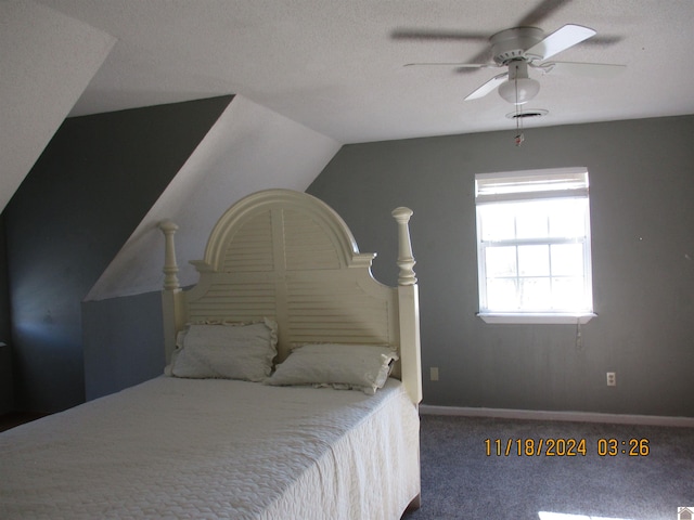 carpeted bedroom with a textured ceiling, ceiling fan, and vaulted ceiling