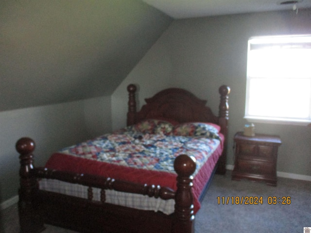 bedroom with carpet and vaulted ceiling