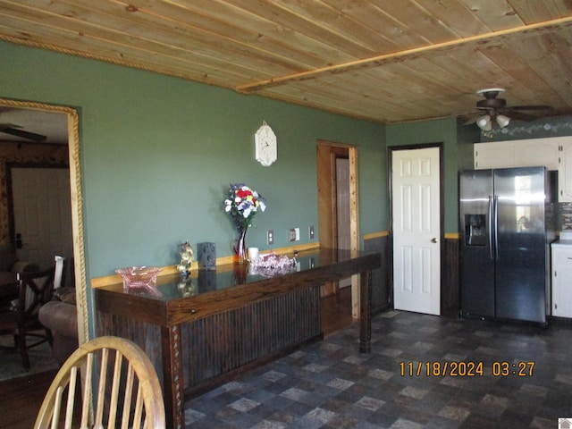 kitchen with ceiling fan, white cabinetry, stainless steel refrigerator with ice dispenser, and wood ceiling