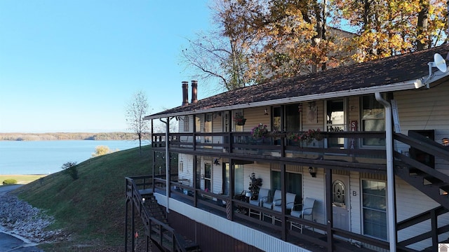 dock area with a water view and a balcony