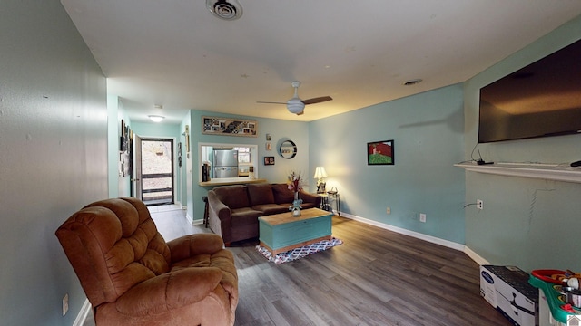 living room featuring hardwood / wood-style flooring and ceiling fan