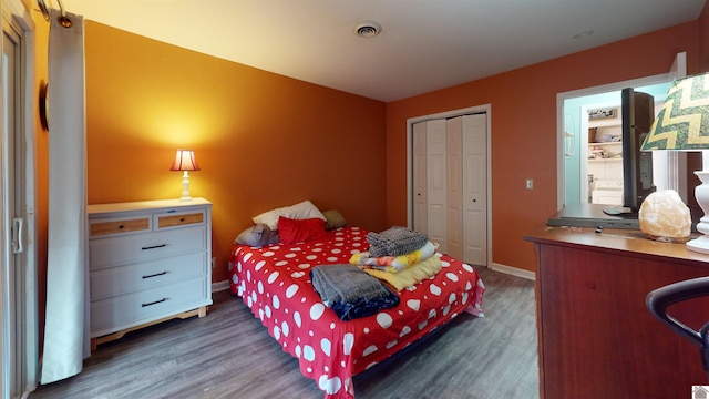 bedroom featuring dark hardwood / wood-style floors and a closet