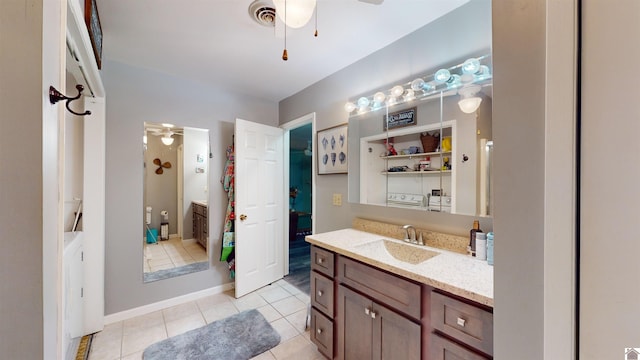 bathroom with tile patterned flooring, ceiling fan, and vanity