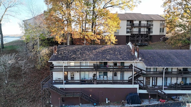 back of property with a balcony and a deck