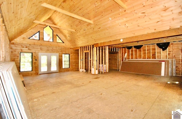 unfurnished living room with french doors, high vaulted ceiling, and wood ceiling