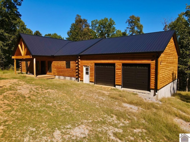 cabin with covered porch and a garage