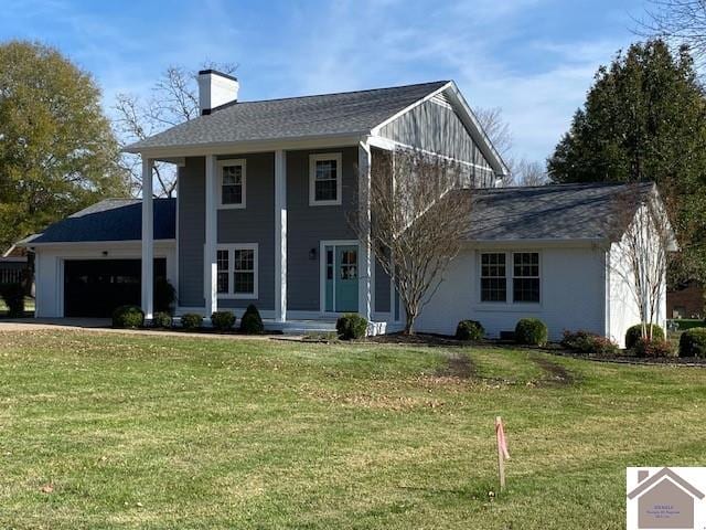 view of front of property with a front yard and a garage