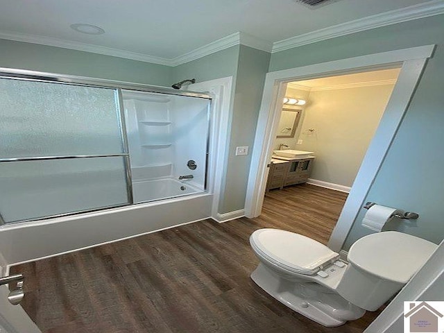 full bathroom featuring enclosed tub / shower combo, crown molding, toilet, vanity, and hardwood / wood-style flooring