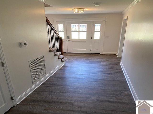 foyer with dark hardwood / wood-style floors and ornamental molding