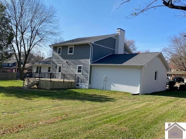 back of house with a yard and a wooden deck