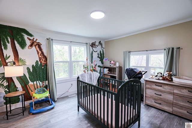 bedroom with dark hardwood / wood-style floors, crown molding, and multiple windows