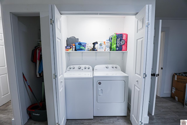 laundry room with washer and clothes dryer and dark wood-type flooring