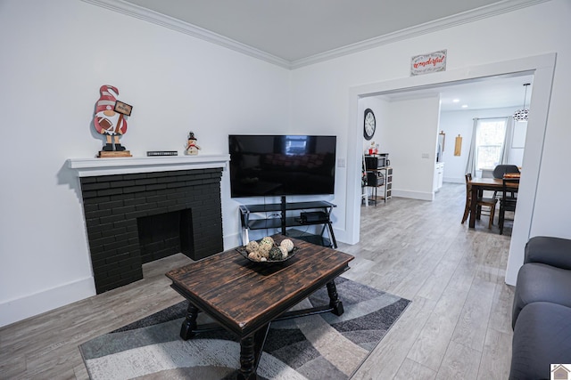 living room with a fireplace, wood-type flooring, and crown molding