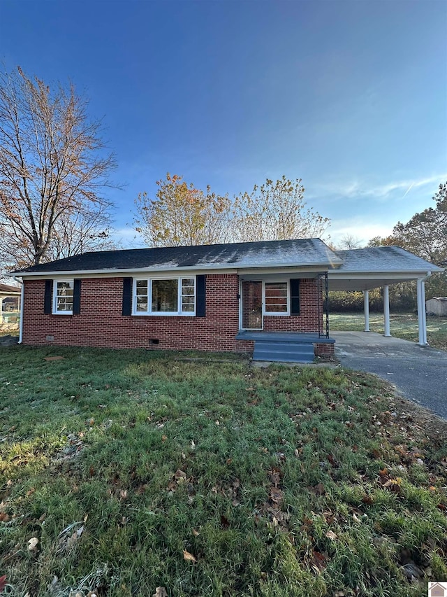 single story home with a front yard and a carport