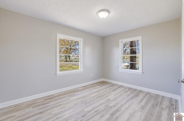 empty room with light hardwood / wood-style flooring