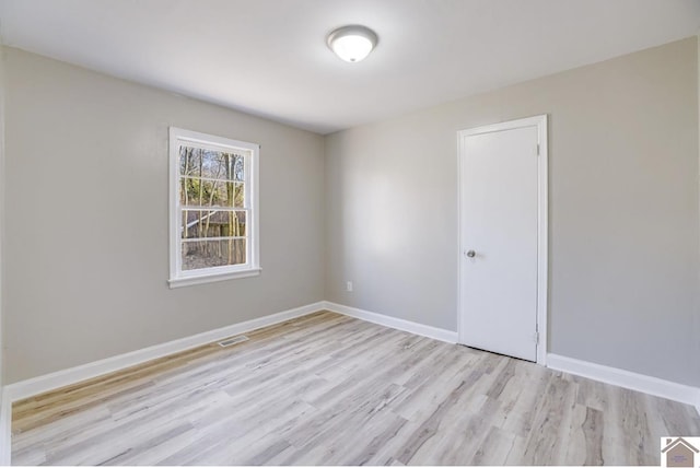 spare room with light hardwood / wood-style flooring