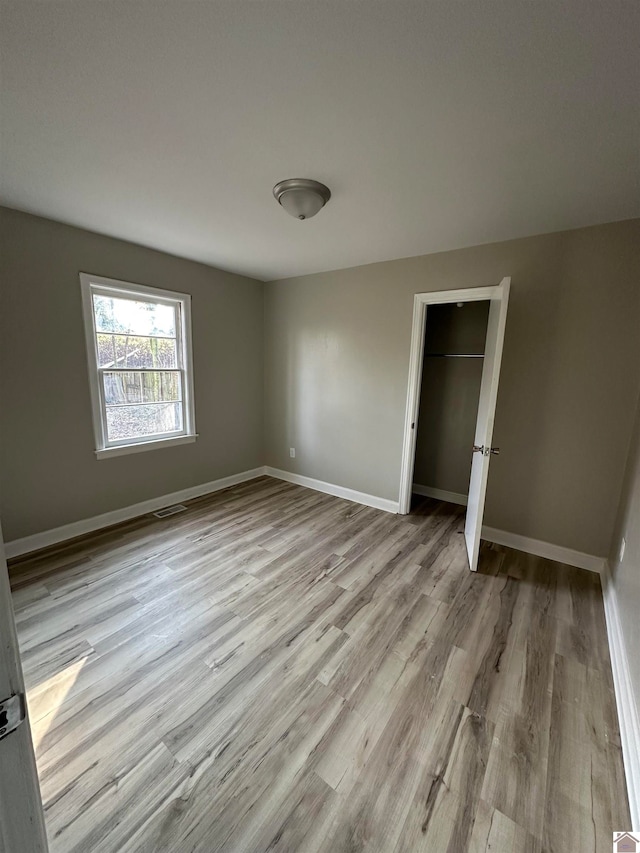 unfurnished bedroom featuring light wood-type flooring