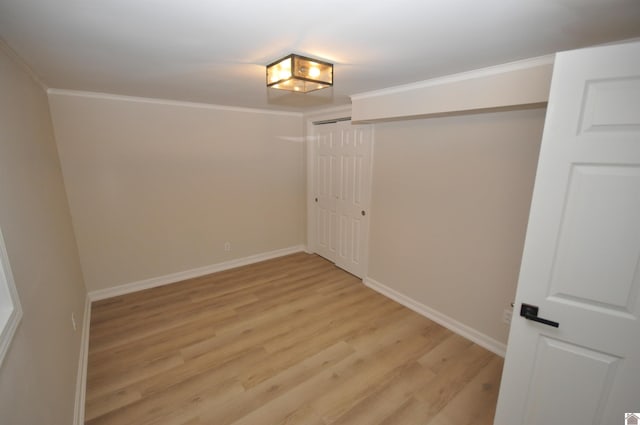 unfurnished room with light wood-type flooring and ornamental molding