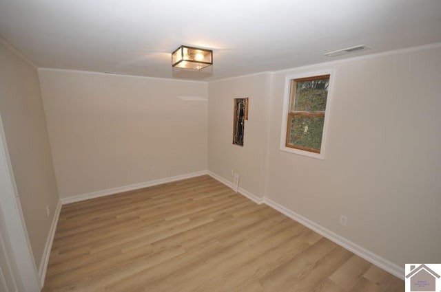 spare room with light hardwood / wood-style floors and ornamental molding