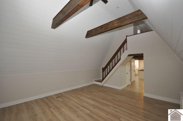 interior space featuring light hardwood / wood-style flooring and lofted ceiling with beams