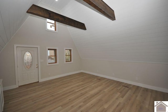 foyer featuring a wealth of natural light, light hardwood / wood-style flooring, and lofted ceiling with beams