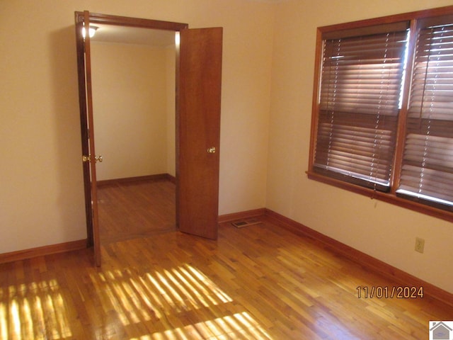 empty room with hardwood / wood-style flooring